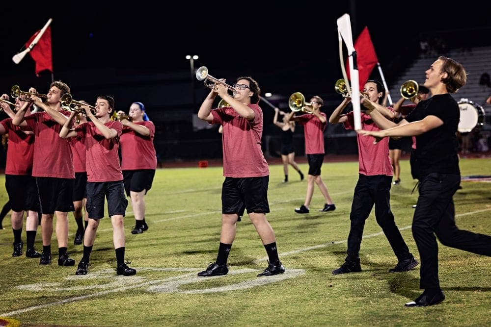 Desert Ridge marching band performing at a home football game
