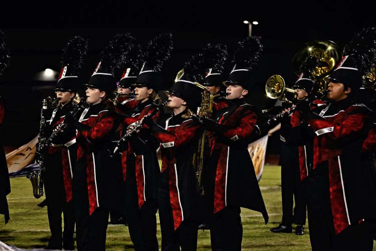 Members in line, playing instruments